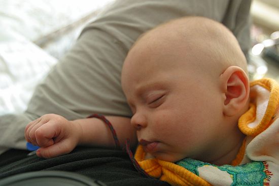 Zeke catches some z-s in dad's lap.