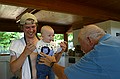 Josh holds Zeke up so that Grandpa can give him tickles.