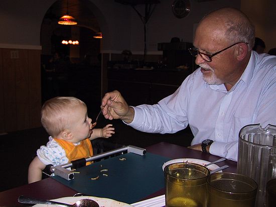 Dad feeds Zeke some spagetti.