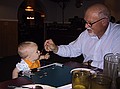 Dad feeds Zeke some spagetti.