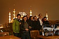 Conference attendees on a rainy rooftop.