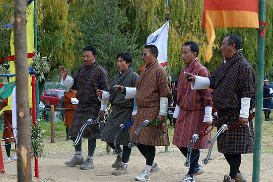 Bhutanese archers dance to celebrate a hit.