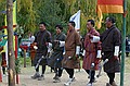 Bhutanese archers dance to celebrate a hit.