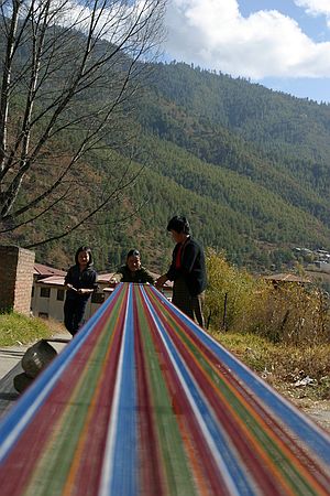Rolling up the loom.