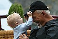 Dad and Zeke play with hats.