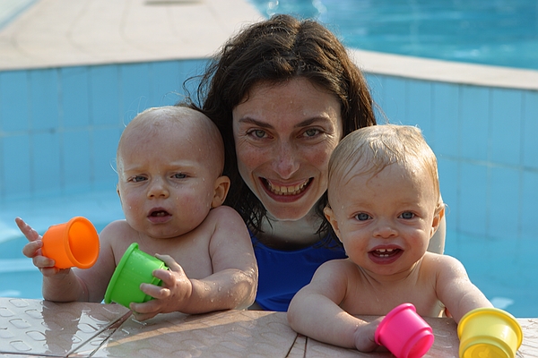 Chilly in the kiddie pool with mom.