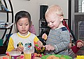 Anh and Gus play with play-doh.