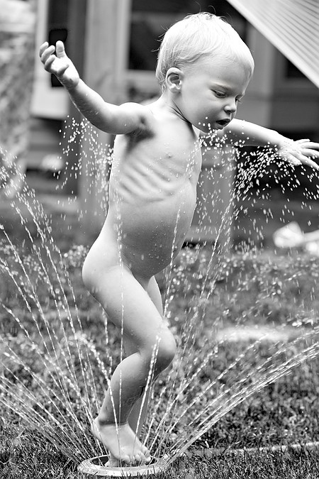 Gus in the sprinkler.